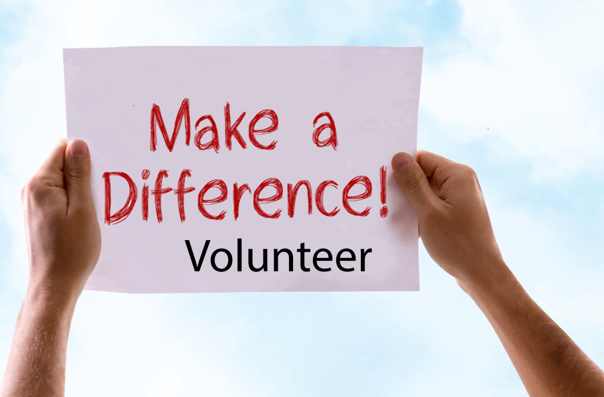 Person holding a sign saying, Make a Difference! Volunteer